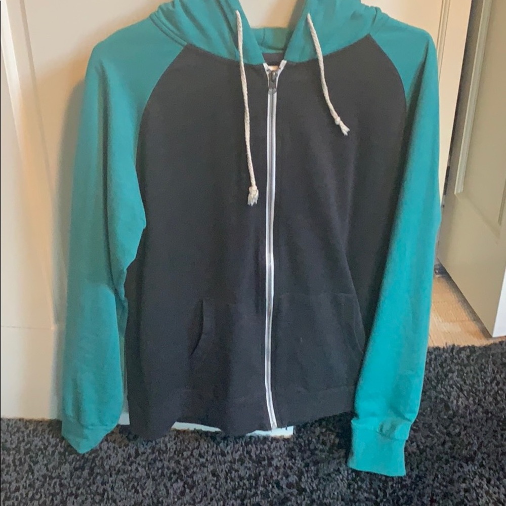 Grey jacket green sleeves and hood